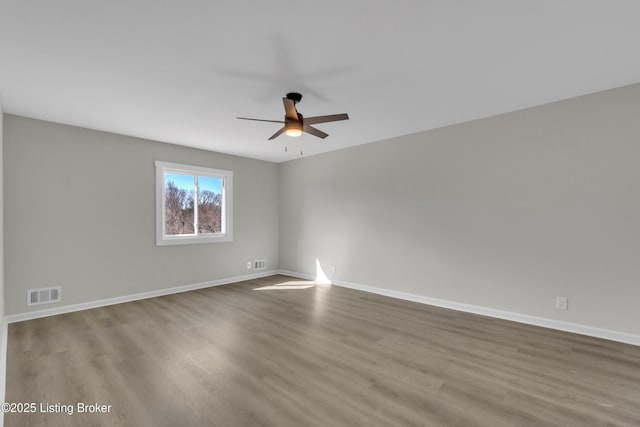 spare room featuring hardwood / wood-style flooring and ceiling fan