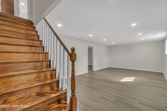 staircase featuring wood-type flooring