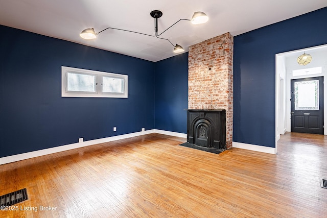 unfurnished living room with hardwood / wood-style flooring