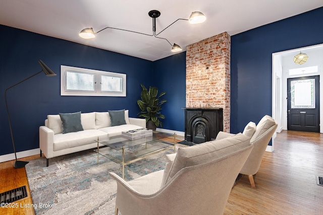 living room with a wealth of natural light and wood-type flooring