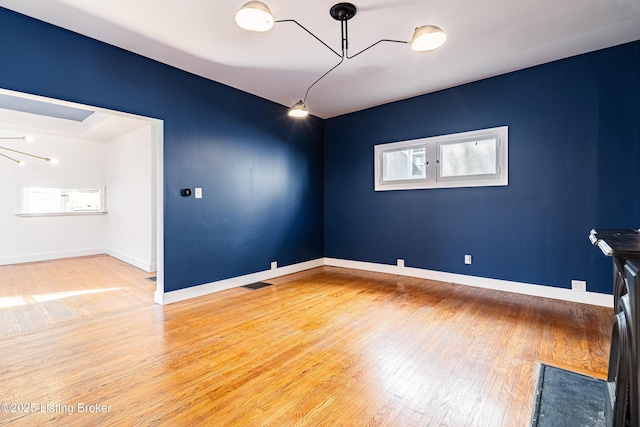 unfurnished room with hardwood / wood-style floors