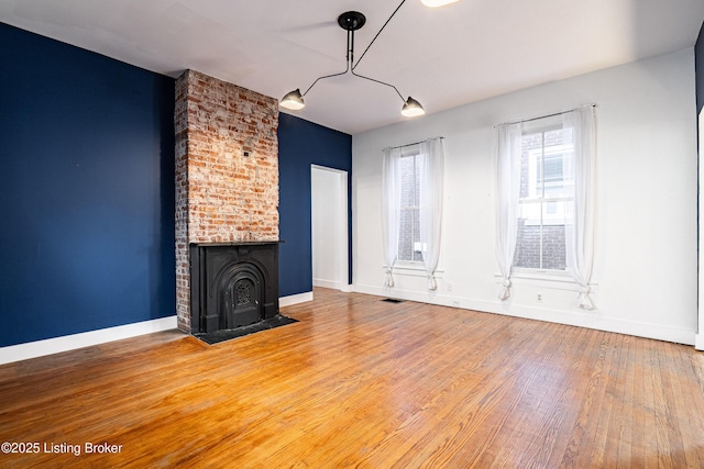 unfurnished living room with wood-type flooring