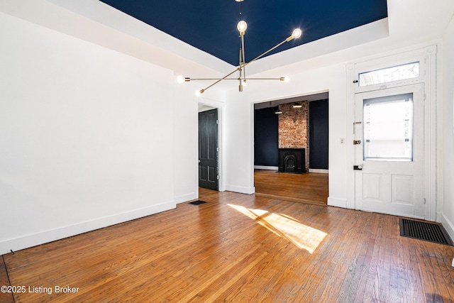 interior space with hardwood / wood-style floors and a tray ceiling