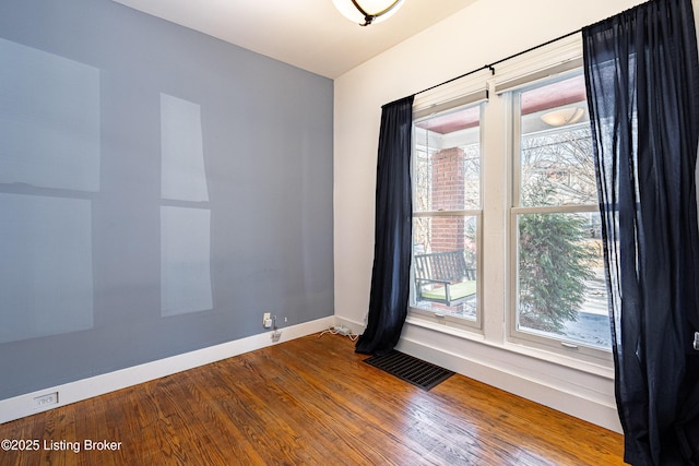 empty room with hardwood / wood-style flooring