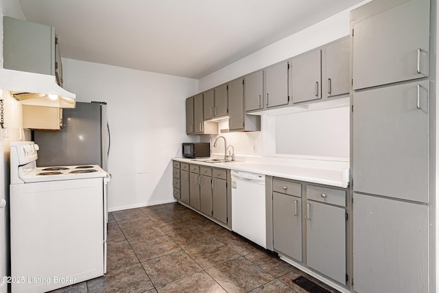 kitchen featuring gray cabinets, sink, white appliances, and range hood