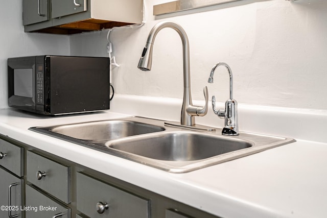 interior details with sink and gray cabinetry