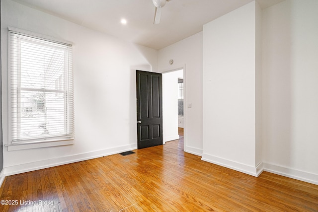 empty room featuring ceiling fan and light wood-type flooring