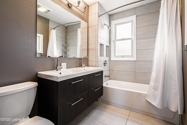 full bathroom with shower / tub combo with curtain, vanity, and toilet