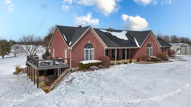 view of front facade featuring brick siding and a deck