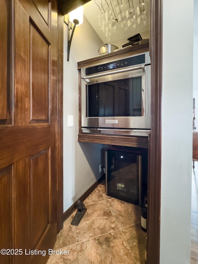 room details with baseboards and stainless steel double oven