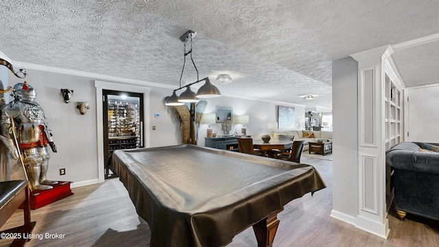 recreation room with crown molding, billiards, and light wood-style floors