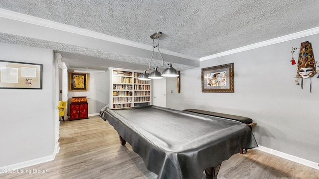 game room featuring light wood-type flooring, a textured ceiling, and crown molding