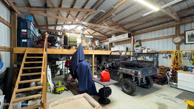 garage featuring a workshop area and metal wall