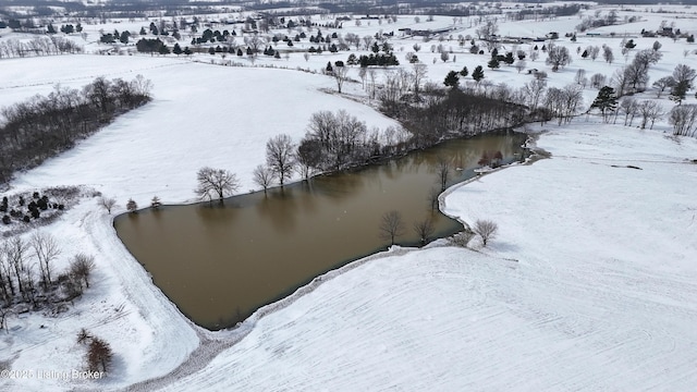 snowy aerial view featuring a water view