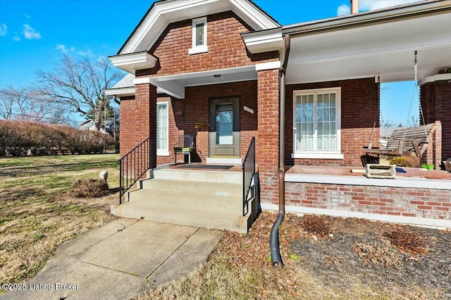 view of exterior entry featuring covered porch