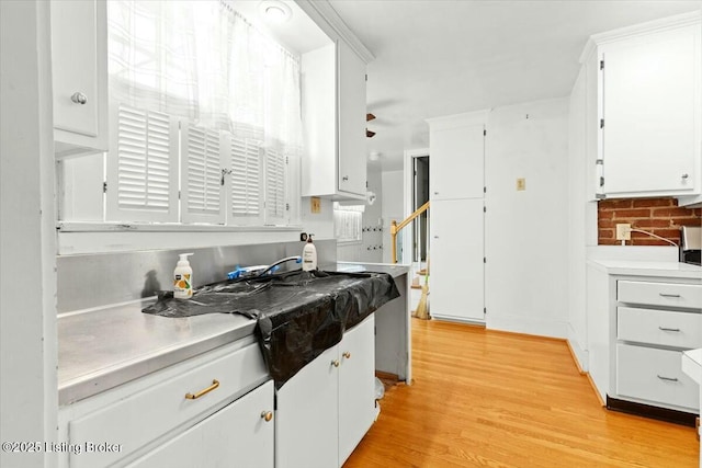 kitchen featuring light hardwood / wood-style floors and white cabinets