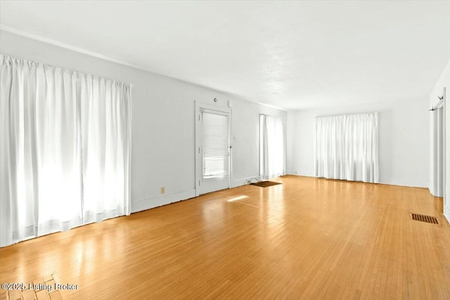 unfurnished living room featuring light wood-type flooring