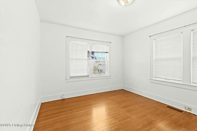 unfurnished room with wood-type flooring