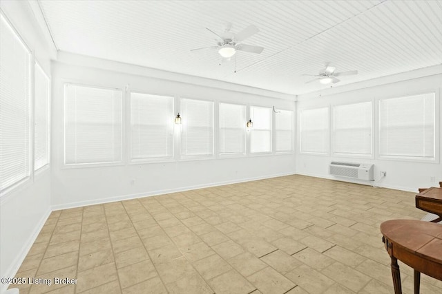 unfurnished sunroom featuring a wall mounted air conditioner and ceiling fan