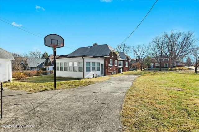 view of side of home with a yard