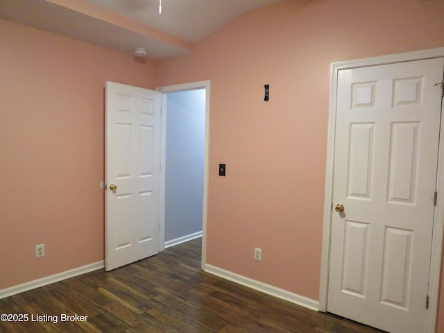 unfurnished bedroom with dark hardwood / wood-style flooring