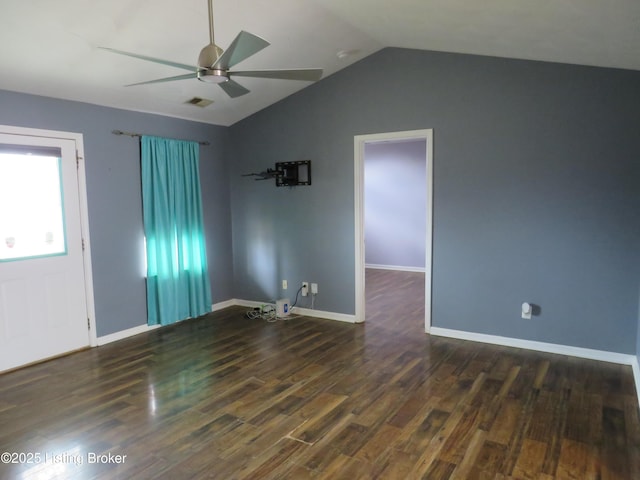 empty room with vaulted ceiling, dark wood-type flooring, and ceiling fan