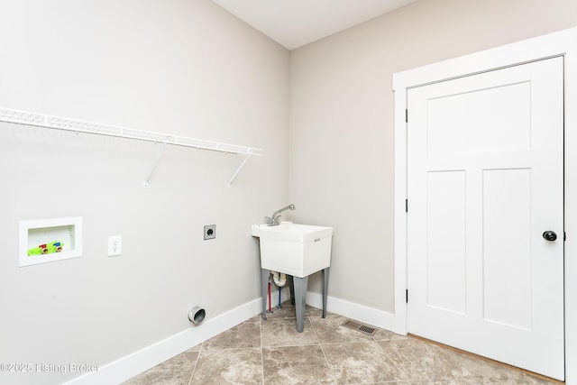 clothes washing area with light tile patterned floors, hookup for a washing machine, and electric dryer hookup