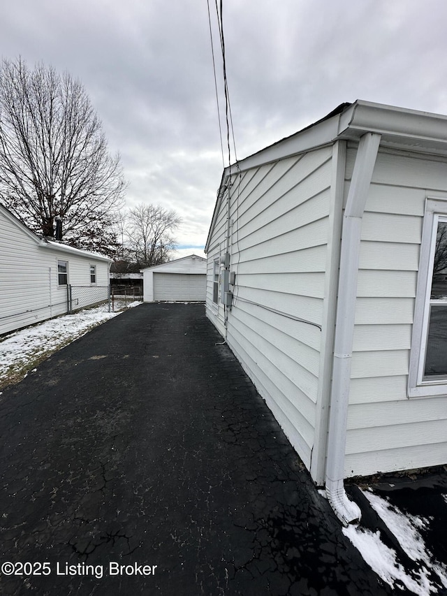 view of side of home with a garage and an outdoor structure