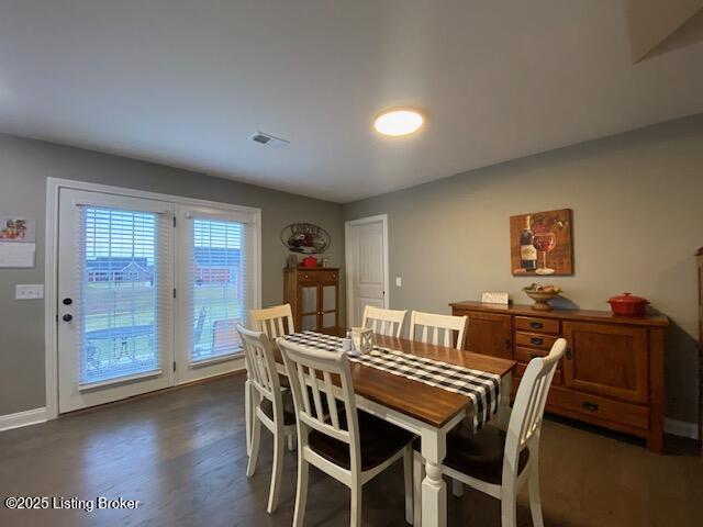 dining space featuring dark wood-type flooring