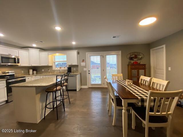 dining area featuring dark hardwood / wood-style floors