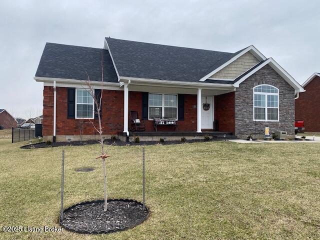 view of front of home featuring a front lawn and a porch