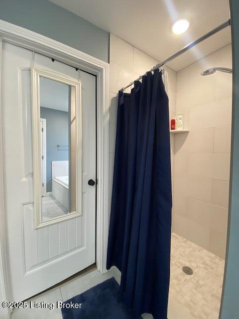 bathroom with tile patterned floors and a shower with shower curtain