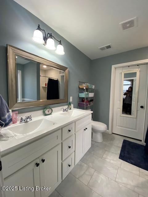 bathroom with vanity and toilet