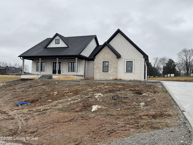 french provincial home featuring covered porch