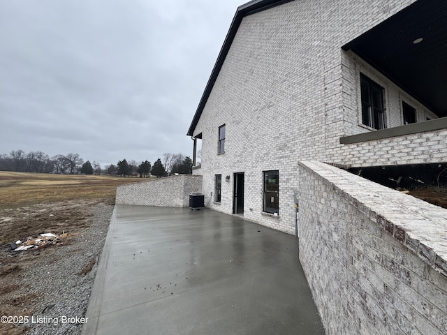 view of property exterior featuring a patio and central AC