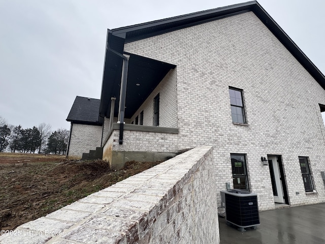 view of side of home featuring central AC