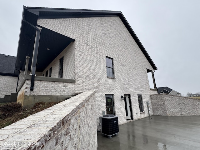 view of side of property featuring central air condition unit