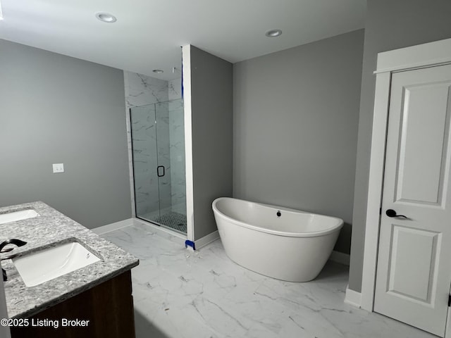 bathroom with vanity and shower with separate bathtub