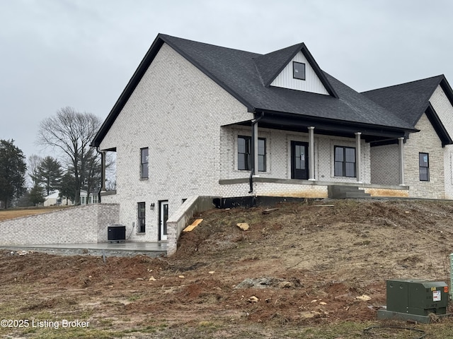 view of front of property with covered porch and central air condition unit