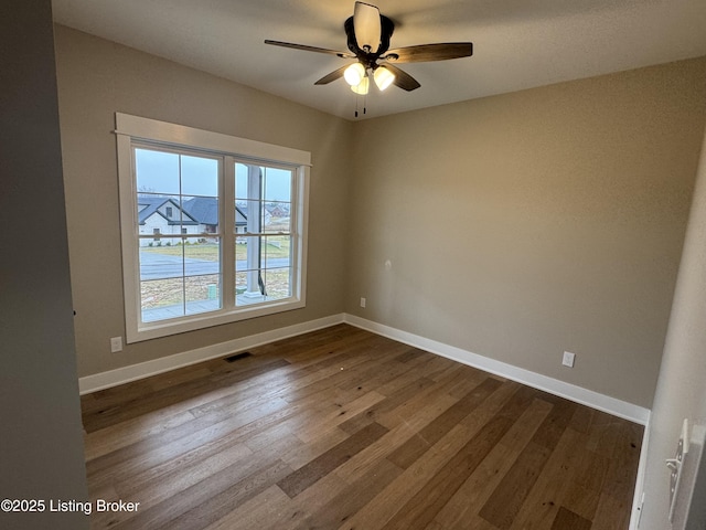 spare room featuring hardwood / wood-style floors and ceiling fan