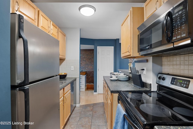 kitchen with light tile patterned flooring, appliances with stainless steel finishes, decorative backsplash, and light brown cabinets