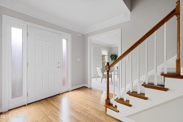 entryway featuring ornamental molding and light wood-type flooring