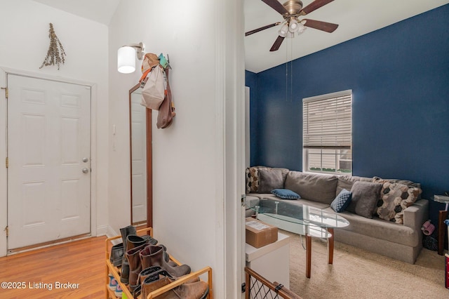 living area featuring ceiling fan and wood finished floors