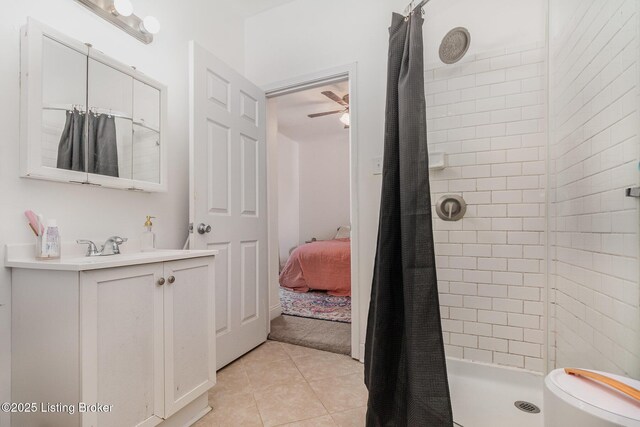 ensuite bathroom with a stall shower, connected bathroom, vanity, ceiling fan, and tile patterned flooring