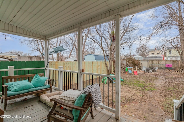 wooden deck with a fenced backyard