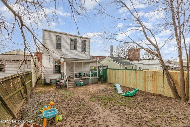 rear view of property with a fenced backyard