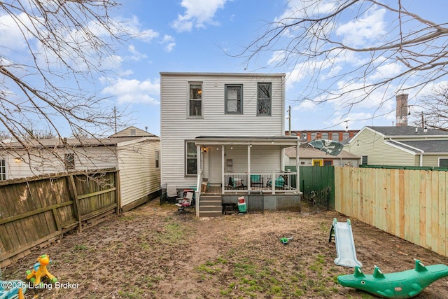 rear view of property with a fenced backyard