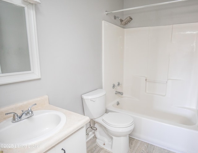 full bathroom with shower / bathing tub combination, vanity, toilet, and wood finished floors