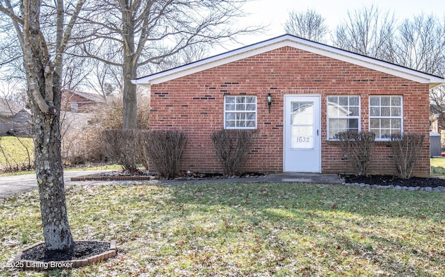 view of front of property with a front yard and brick siding