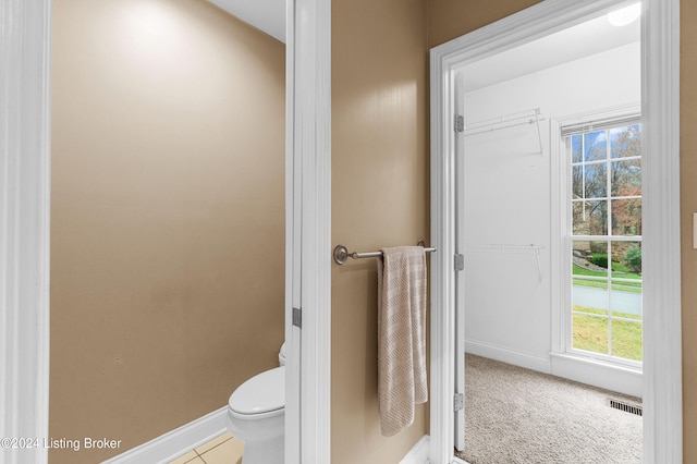 bathroom with visible vents, toilet, and baseboards